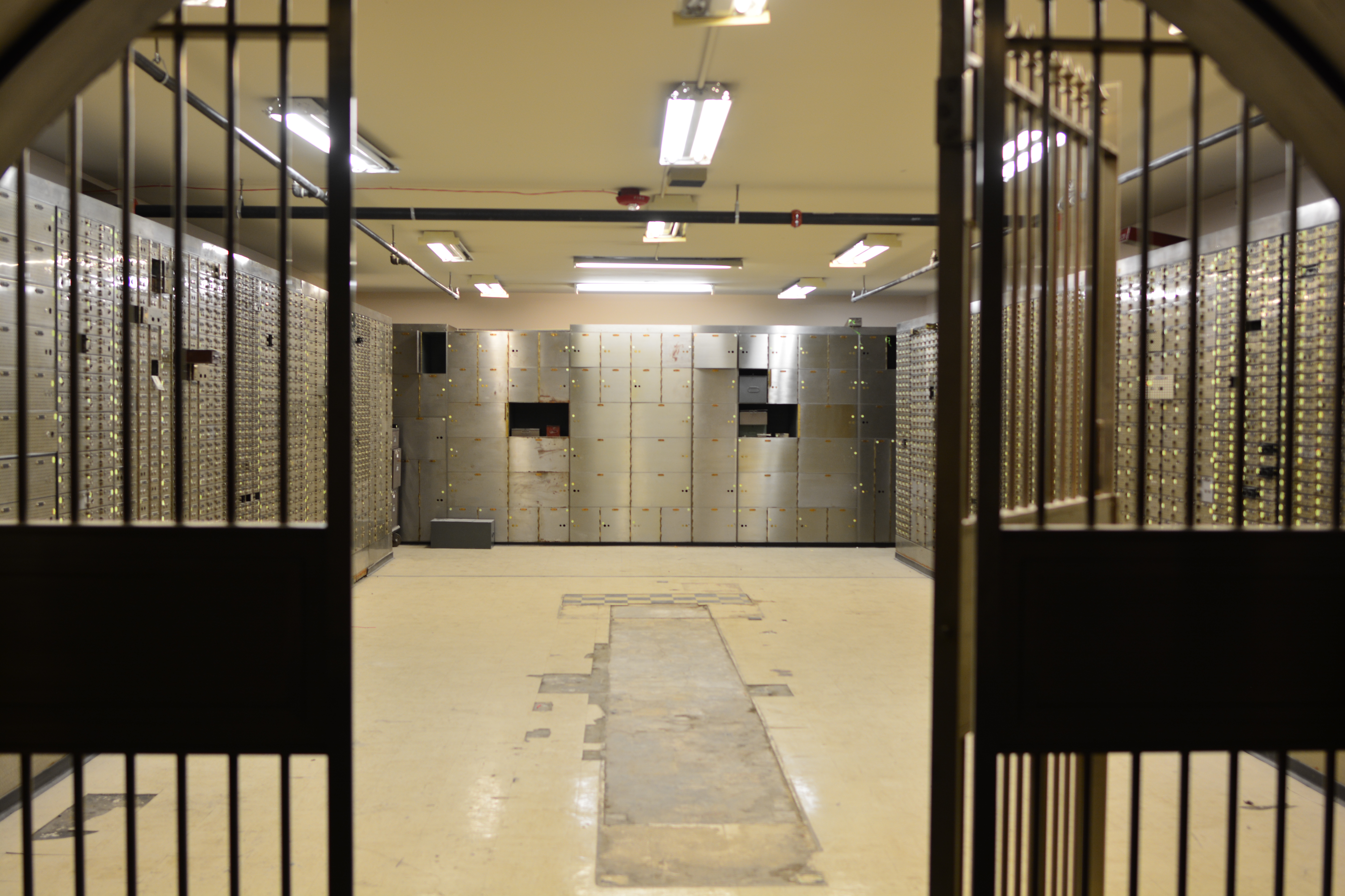A wall of vintage bank safe deposit boxes — a metaphor for per-user encrypted vaults